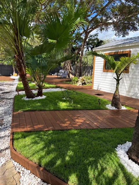 Wood deck walkway connecting tropical garden areas