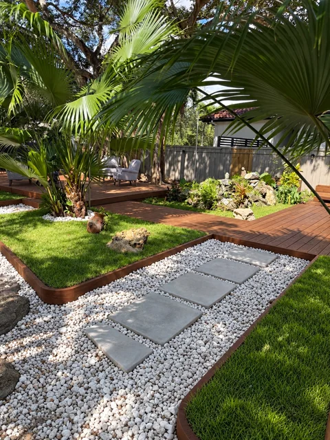 Curved wood garden border beside a stone and paver path