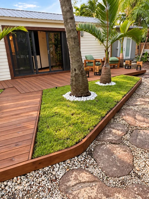 Custom wood deck with a curved edge around an integrated tropical garden