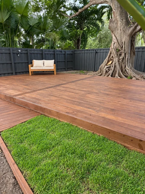 Custom deck with contrasting border boards and tropical surroundings