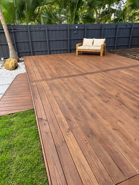 Stained wood deck with a framed board layout