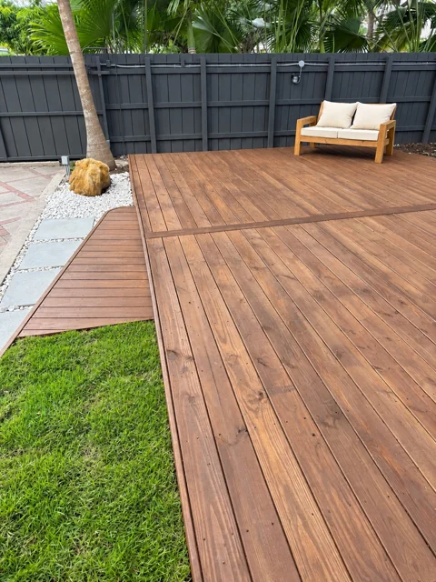 Finished deck with curved step and decorative garden border