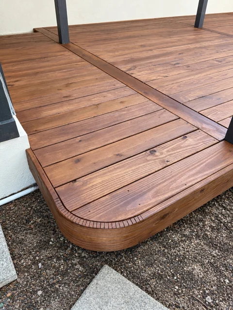 Close-up of a curved deck corner and wood grain finish