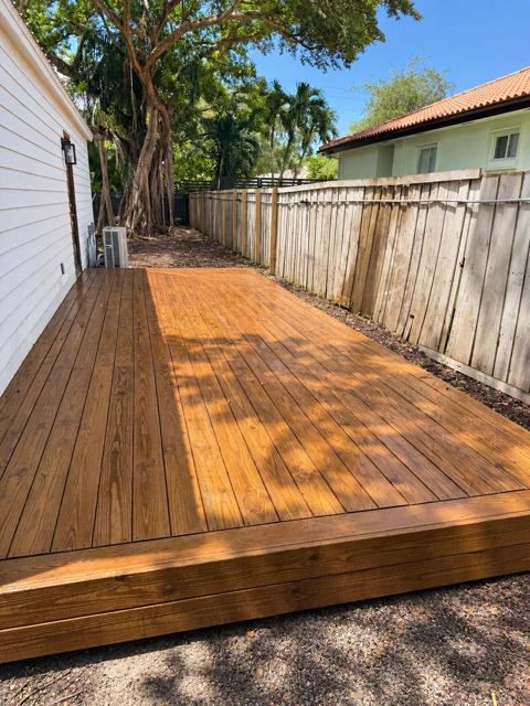 Custom wood deck beside a home with a framed perimeter