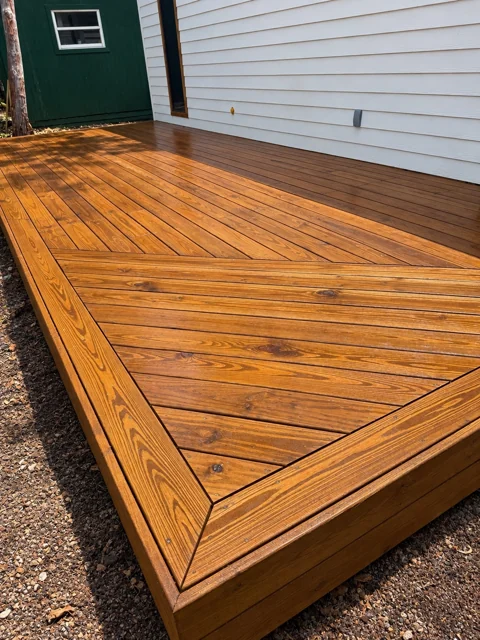 Angled wood deck boards with detailed perimeter trim