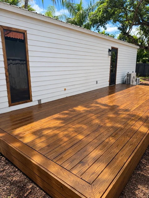 Finished wood deck along the side of a home